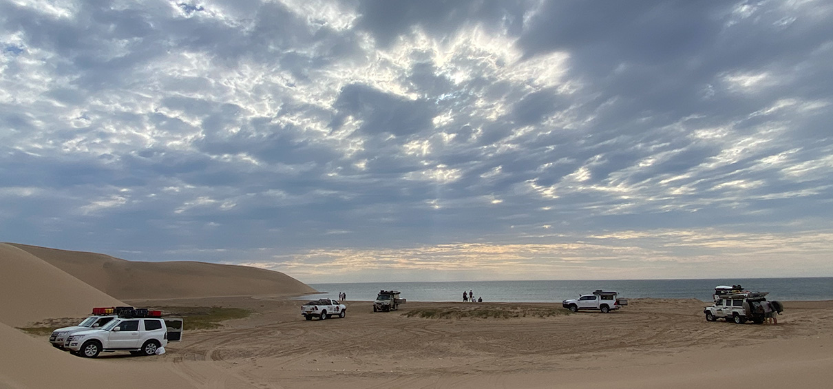 view of the campsite at Sandwich Harbour with sea in the background